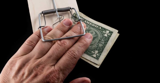 Man's fingers caught in a mousetrap