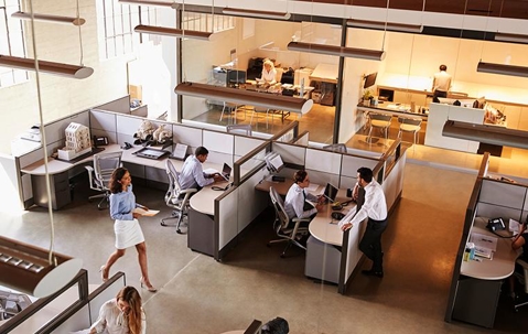 Large commercial office building interior with people working in their cubicles.